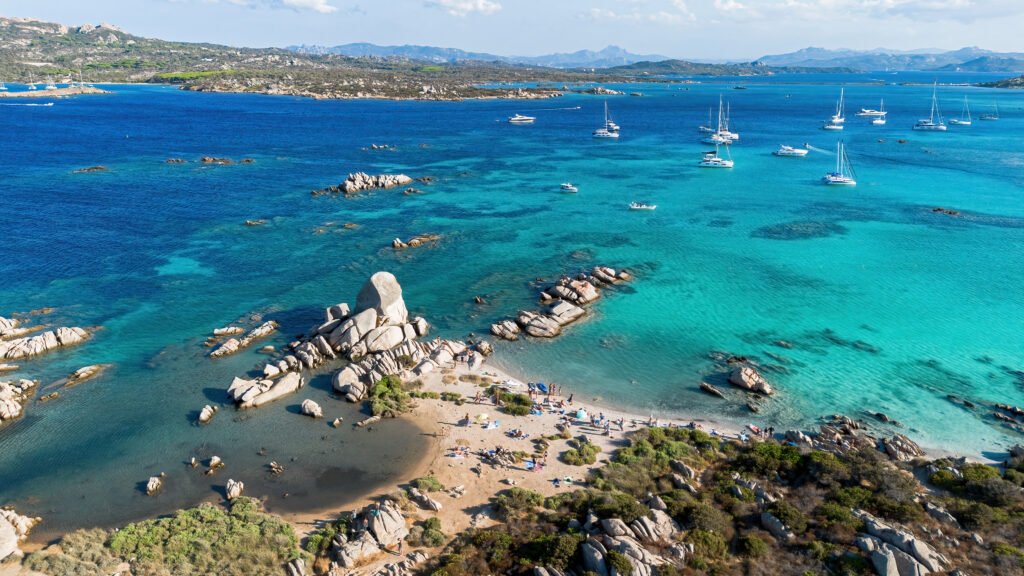 Aerial view of Capocchia d'u purpu beach (Testa del Polpo) and its iconic granite rock on Giardinelli island in La Maddalena archipelago, Sardinia, Italy
